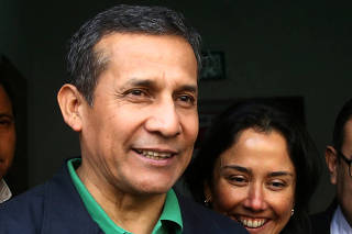 Peru's former President Ollanta Humala and former first lady Nadine Heredia leave the Nationalist Party headquarters in Lima
