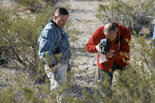 A photo provided by NASA shows from left, Neil Armstrong and Buzz Aldrin documenting samples during geological training at Sierra Blanca in West Texas, Feb. 24, 1969. (NASA via The New York Times)