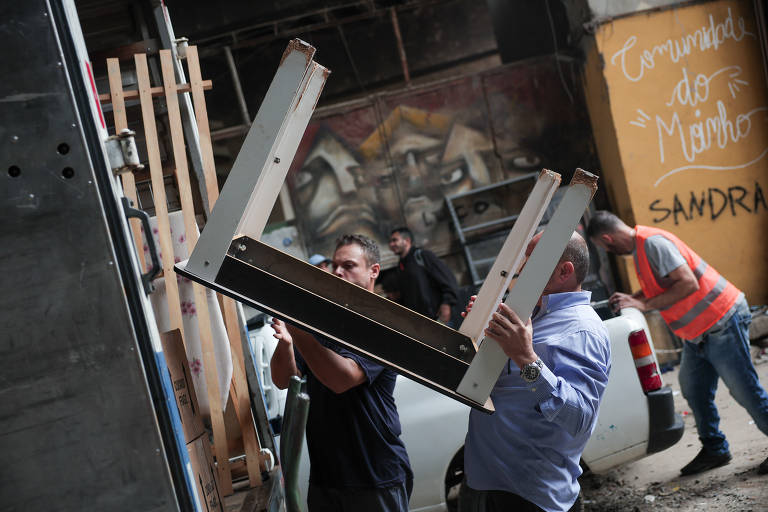 Caminhão sendo carregado com móveis durante retirada de famílias da favela