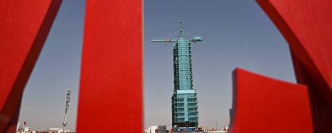 TOPSHOT - The Long March-2F carrier rocket, carrying the Shenzhou-20 spaceship, is seen encased in blue scaffolding on the launch pad a day before the launch of the Shenzhou-20 mission, at the Jiuquan Satellite Launch Centre in the Gobi desert in northwest China on April 23, 2025. China is expected to launch a new crewed mission into space this week, as Beijing takes steady steps towards its goal of putting astronauts on the Moon. (Photo by Pedro Pardo / AFP)