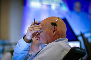 Traders work on the floor of the NYSE in New York