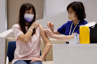 Yoyo Liang, from mainland China, received a dose of BioNTech bivalent coronavirus disease (COVID-19) vaccine at a private clinic in Hong Kong