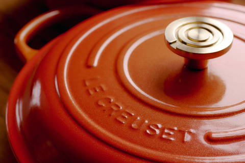 Two Le Creuset pots in the companyÕs latest color, Flamme Dore (golden flame), are displayed for a photograph in New York on April 2, 2025. In 1925, Le CreusetÕs line of enamel-coated cast-iron cookware came in a single color: Volcanique, or Flame. For its 100th anniversary, the company has added a gold shimmer to the color. (Vincent Tullo/The New York Times) ORG XMIT: XNYT0626