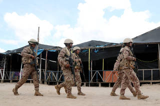 FILE PHOTO: Peruvian military walk at an illegal gold mining camp operation to destroy illegal machinery and equipment used by wildcat miners in Madre de Dios