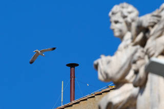 Firefighters work to set a chimney on the roof of the Sistine Chapel, ahead of the conclave, at the Vatican