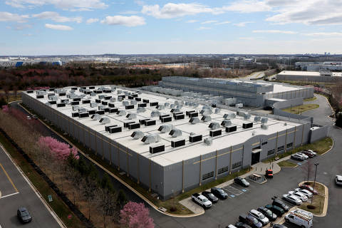 FILE PHOTO: A car drives past a building of the Digital Reality Data Center in Ashburn, Virginia, U.S., March 17, 2025. REUTERS/Leah Millis/File Photo ORG XMIT: FW1