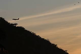 A plane flies over Rio de Janeiro as it prepares to land at Santos Dumont airport