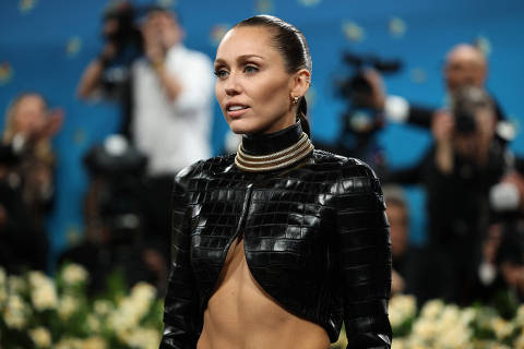 Miley Cyrus poses during the Met Gala, an annual fundraising gala held for the benefit of the Metropolitan Museum of Art's Costume Institute with this year's theme 'Superfine: Tailoring Black Style,' in New York City, New York, U.S., May 5, 2025. REUTERS/Mario Anzuoni