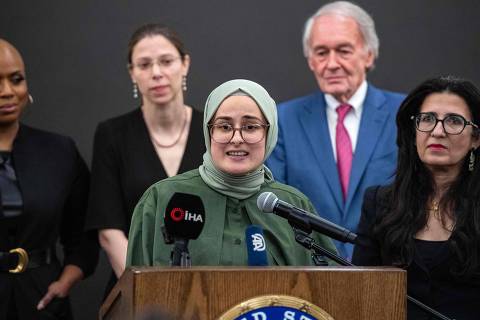 Rumeysa Ozturk (C) speaks at a press conference at Logan International Airport in Boston, Massachusetts on May 10, 2025. US Judge William Sessions on May 9, 2025, ordered Ozturk's release after she was detained on March 25, 2025 by federal agents as part of US President Donald Trump's crackdown on pro-Palestinian campus activism. (Photo by Joseph Prezioso / AFP)