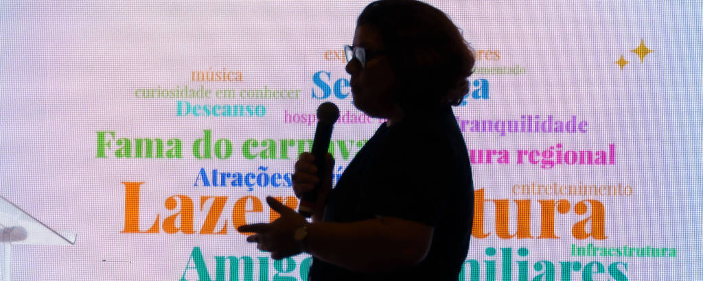 A imagem mostra a silhueta de uma mulher em um palco, segurando um microfone. Ao fundo, há um painel com várias palavras relacionadas a lazer e cultura, como 'música', 'descanso', 'tranquilidade', 'atrações', 'infraestrutura', entre outras. A iluminação do painel é colorida, destacando as palavras em diferentes tonalidades.