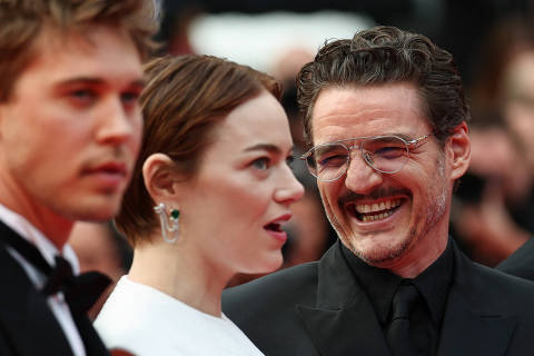 Cast members Emma Stone, Pedro Pascal, and Austin Butler pose on the red carpet during arrivals for the screening of the film 
