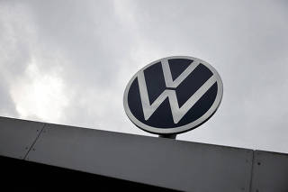 FILE PHOTO: A VW logo is pictured on a day of an announcement of Volkswagen AG job cuts and closure of its few factories, at the company's headquarters in Wolfsburg