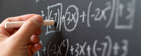 Mathematical operations and algebra mathematic formula written with chalk on the blackboard