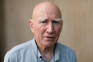 FILE PHOTO: Brazilian photographer Salgado poses for a portrait after an interview with Reuters in Bangkok