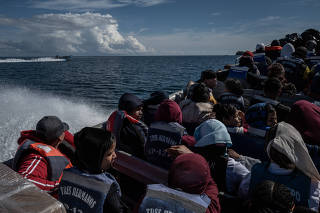 A boat of migrants on their journey back south from Panama to Colombia, May 6, 2025. (Federico Rios Escobar/The New York Times)