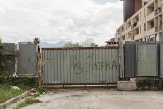 A graffiti tag reading ÒNo to GomorraÓ on a gate near the Vele housing complex in Scampia, Naples, Italy, on April 2, 2025. (Gianni Cipriano/The New York Times)