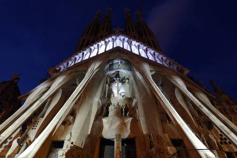 The facade of Spanish architect Antoni Gaudi's Sagrada Familia Basilica is lit up in colours during a light show marking the start of the Holy Week, in Barcelona on April 14, 2025. The Catholic Church has put Antoni Gaudi, the designer of Barcelona's Sagrada Familia basilica nicknamed 