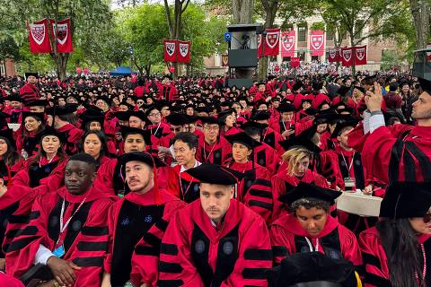(FILES) Graduates gather as they attend commencement ceremony at Harvard University in Cambridge, Massachusetts, on May 29, 2025. US President Donald Trump's late night proclamation on June 4, 2025, blocking Harvard's new international students has sparked fear and anger among existing students left in limbo amid the escalating showdown between the president and their university. (Photo by Rick Friedman / AFP)
