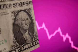 FILE PHOTO: Illustration shows U.S. dollar banknote and decreasing stock graph