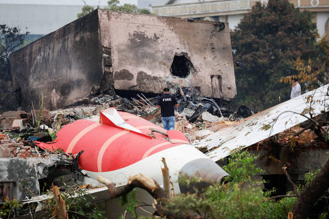A fire officer stands next to the crashed Air India Boeing 787-8 Dreamliner aircraft, in Ahmedabad, India, June 13, 2025. REUTERS/Adnan Abidi     TPX IMAGES OF THE DAY ORG XMIT: LIVE