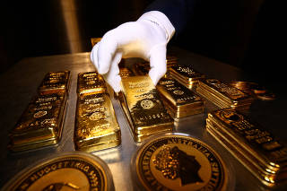 FILE PHOTO: Gold bars and coins are stacked in the safe deposit boxes room of the Pro Aurum gold house in Munich