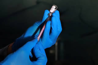 Amar Vennapusa fills a syringe with Eli Lilly's Mounjaro at his health clinic in Hyderabad