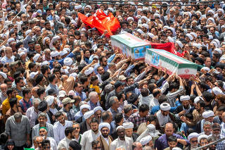Mourners attend a funeral for those killed amid the Iran-Israel conflict, in Qom