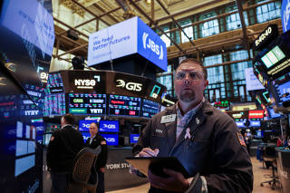 Traders work on the floor at the New York Stock Exchange (NYSE) in New York City