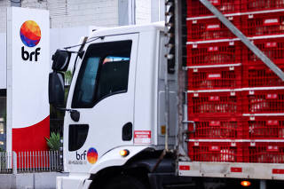 FILE PHOTO: A truck loaded with chickens passes in front of a unit of BRF S.A., in Lajeado