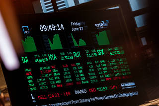 Traders work at NYSE in New York City