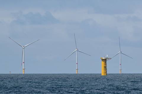This photograph shows the Yeu-Noirmoutier offshore windmills farm off the coast L'Ile-d'Yeu (Yeu Island), western France on June 23, 2025. (Photo by Damien MEYER / AFP)