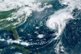 FILE PHOTO: Hurricane Ernesto moves on in the Atlantic Ocean after making landfall on Bermuda