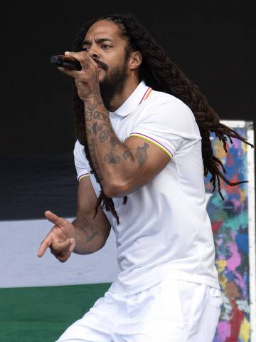 To the backdrop of a Palestinian flag, Bobby Vylan of British duo Bob Vylan performs on the West Holts Stage on the fourth day of the Glastonbury festival at Worthy Farm in the village of Pilton in Somerset, south-west England, on June 28, 2025. (Photo by Oli SCARFF / AFP)