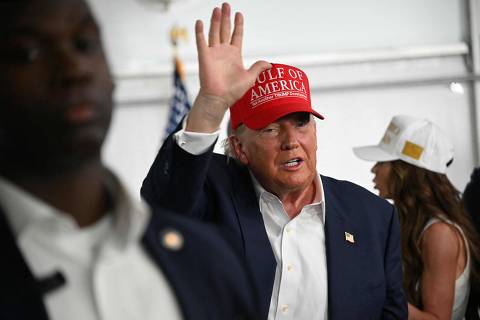 US President President Donald Trump waves as he visits a migrant detention center, dubbed 