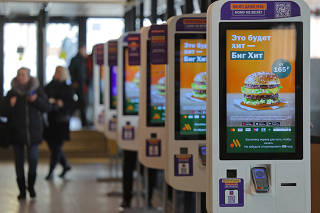 A view shows self-service kiosks advertising a Big Hit burger at Vkusno & tochka fast food restaurant in Moscow