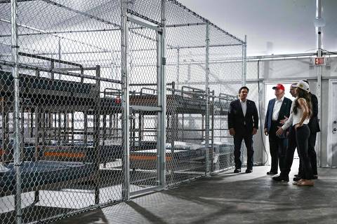 TOPSHOT - US President President Donald Trump (2L), Florida Governor Ron DeSantis (L), and Secretary of Homeland Security Kristi Noem (R) tour a migrant detention center, dubbed 