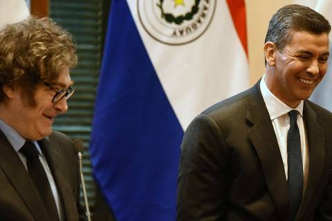 Argentina's President Javier Milei (L) and Paraguay's President Santiago Peña share a laugh during a joint press conference following a meeting at the Palacio de Lopez government palace in Asuncion on April 9, 2025. (Photo by DANIEL DUARTE / AFP)