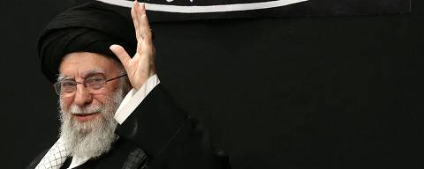 This handout picture released by the office of Iran's Supreme Leader Ayatollah Ali Khamenei on July 5, 2025 shows him waving to the audience during a mourning ceremony in Tehran marking the ninth day of the Islamic month of Muharram in the lead-up to Ashura, a 10-day period commemorating the seventh century killing of Prophet Mohammed's grandson Imam Hussein. (Photo by LEADER OFFICE / AFP) / === RESTRICTED TO EDITORIAL USE - MANDATORY CREDIT 