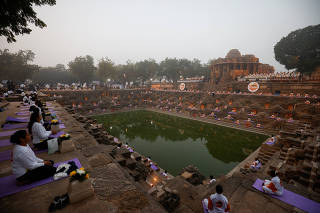 Participants meditate to welcome the new year at the Sun Temple in Modhera village
