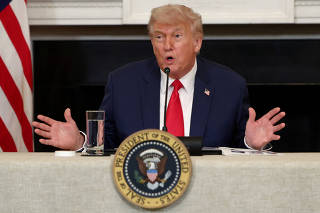 FILE PHOTO: U.S. President Donald Trump participates in an Invest America Roundtable, at the White House, in Washington