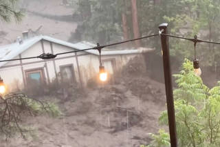A flood sweeps away a house in Ruidoso