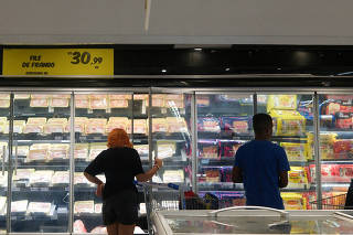 FILE PHOTO: People shop for meat in a Carrefour supermarket in Sao Paulo