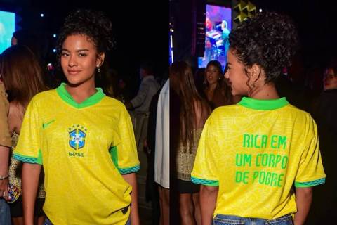 Bella Campos passeia com frase divertida às costas