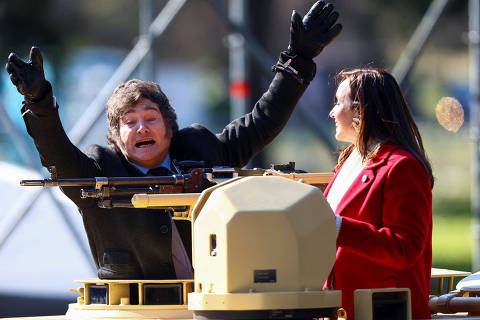Argentina's President Javier Milei gestures from a military vehicle next to Vice President Victoria Villarruel, during a military parade commemorating the 208th anniversary of the country's independence from Spain in 1816, in Buenos Aires, Argentina July 9, 2024. REUTERS/Matias Baglietto ORG XMIT: LIVE