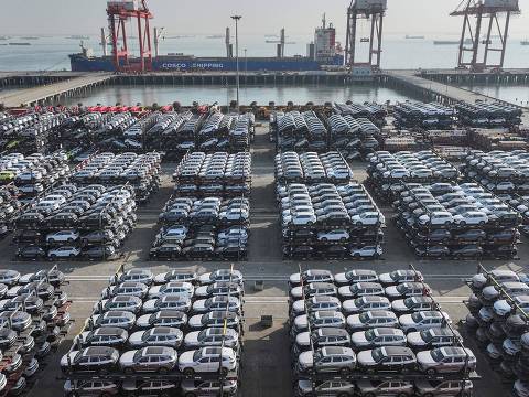 TOPSHOT - This aerial view shows BYD electric cars that will be exported to South America stacked at the Taicang Port in Suzhou, in Chinas eastern Jiangsu province on April 8, 2025. (Photo by STRINGER / AFP) / China OUT