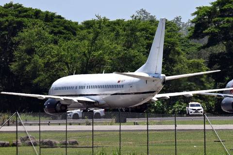 A plane carrying Venezuelan migrants jailed in El Salvador prepare to depart bound for Venezuela at the tarmac of San Oscar Romero International Airport in San Luis Talpa, El Salvador, on July 18, 2025. (Photo by MARVIN RECINOS / AFP)