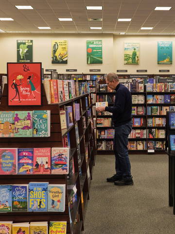 A patron in the revamped Barnes and Nobles location in Hingham, Mass., March 24, 2022. After years on the decline, Barnes & NobleÕs sales are up, its costs are down, and the some of the same people who for decades saw the superchain as a supervillain Ñ independent booksellers Ñ are celebrating its success. (Cody O'Loughlin/The New York Times) ORG XMIT: XNYT96