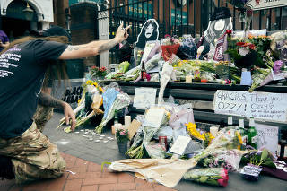 Fans visit an impromptu memorial for Ozzy Osbourne on Black Sabbath Bridge in Birmingham, England, on Wednesday, July 23, 2025. (Ellie Smith/The New York Times)