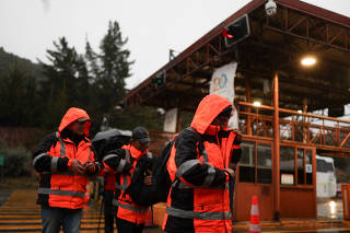 Workers leave at the El Teniente copper mine complex, in Maitenes