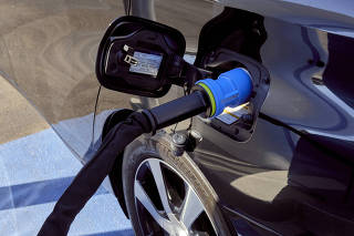 A hydrogen-powered car fuels up at a gas station in Fountain Valley, Calif. (Philip Cheung/The New York Times)
